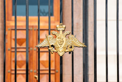 Close-up of cross on metal outside building