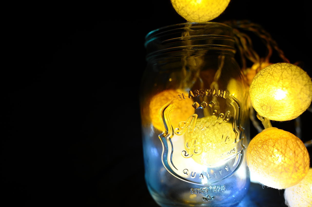 CLOSE-UP OF GLASS JARS ON TABLE