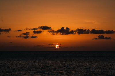 Scenic view of sea against romantic sky at sunset
