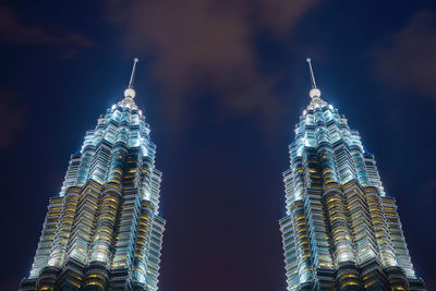 Low angle view of illuminated building against sky at night