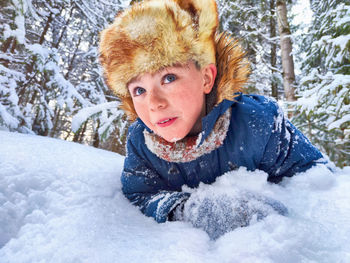 Portrait of smiling young woman in snow