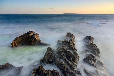 High angle view of rock formations in sea