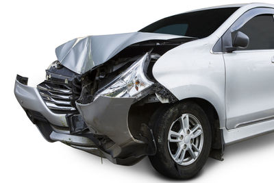 Damaged car against white background