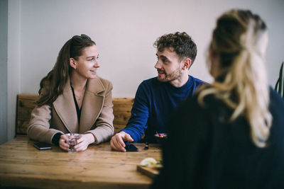 Young couple sitting on table