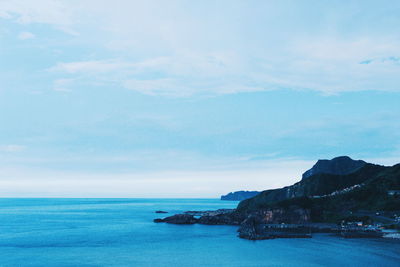 Scenic view of sea against blue sky