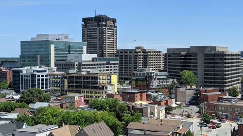 Buildings in city against clear sky