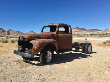 View of abandoned car on desert