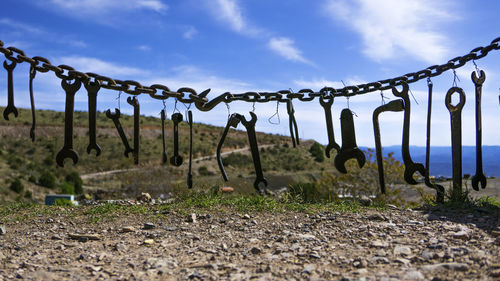 Close-up of hanging against sky