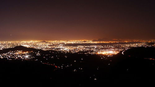 Aerial view of illuminated cityscape at night