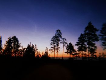 Silhouette trees against clear sky during sunset