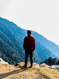 Rear view of man standing on mountain