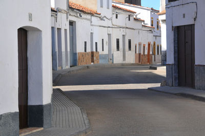 Empty alley amidst buildings in city