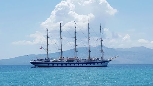 Ship sailing on sea against sky