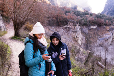 Friends standing on mountain