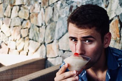 Portrait of man holding ice cream outdoors