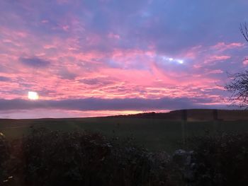 Scenic view of field against sky during sunset