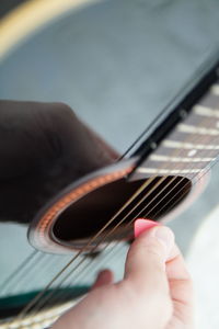 Midsection of person playing guitar