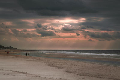 Scenic view of beach against sky during sunset