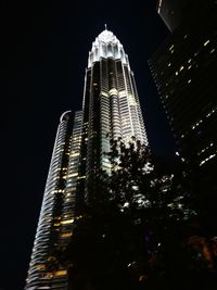 Low angle view of skyscrapers lit up at night