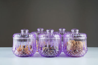 Close-up of bottles in jars against white background