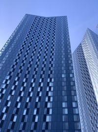 Low angle view of modern building against clear blue sky