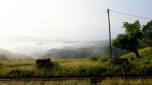 Scenic view of landscape and mountains against clear sky