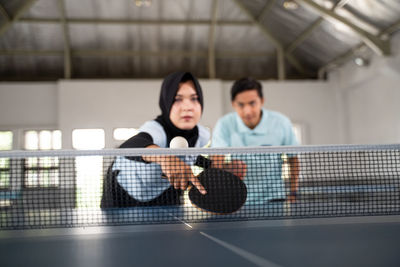 Portrait of young woman playing tennis