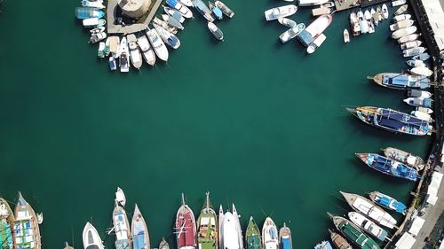 High angle view of sailboats moored at harbor