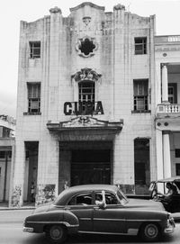 Car on road against buildings in city