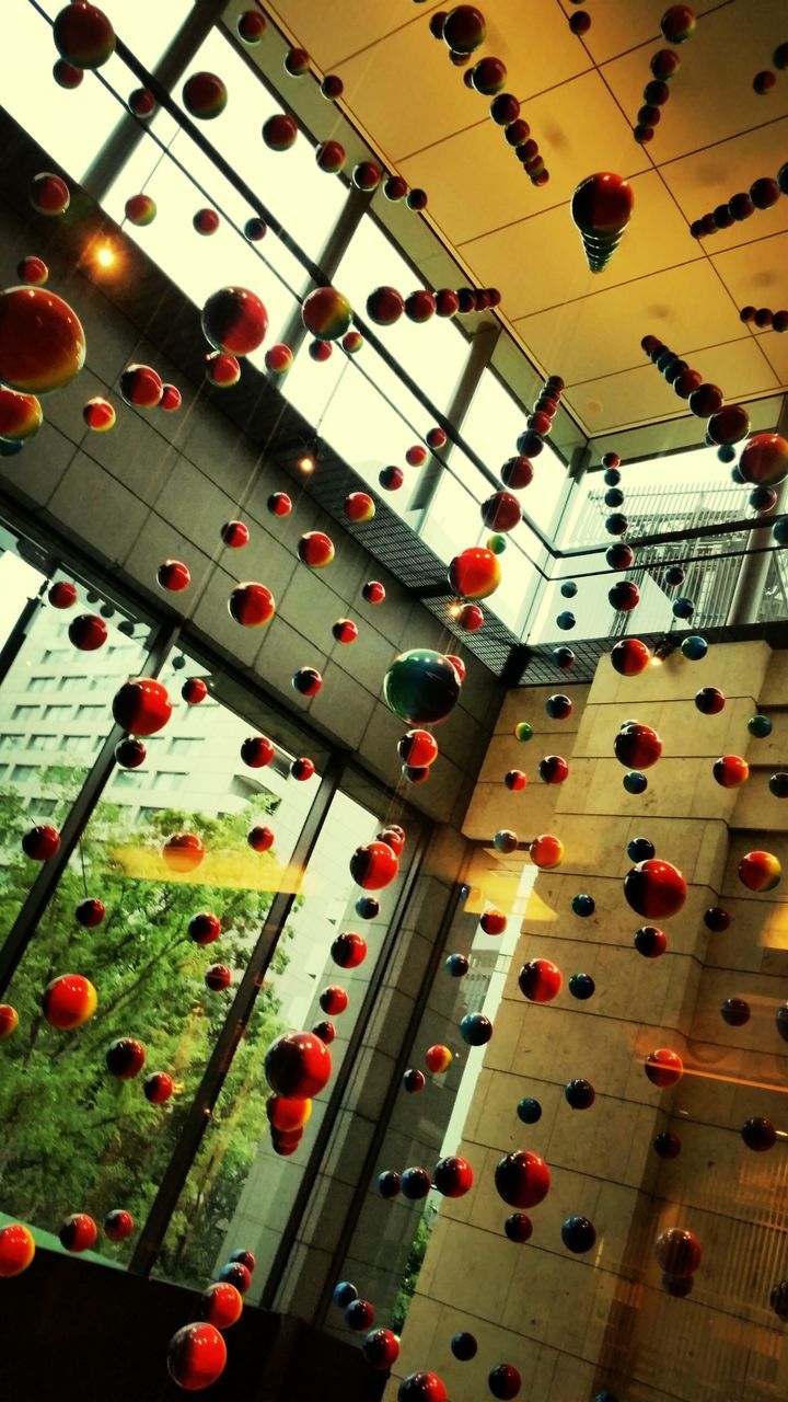 indoors, low angle view, hanging, large group of objects, in a row, multi colored, ceiling, abundance, red, decoration, lighting equipment, high angle view, variation, illuminated, no people, cultures, metal, backgrounds, arts culture and entertainment, celebration