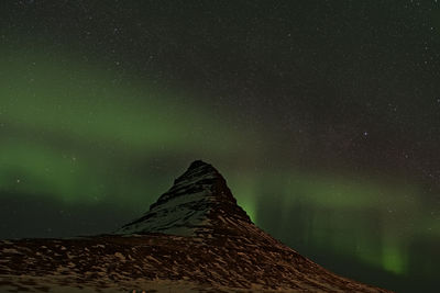 Low angle view of mountain against sky at night