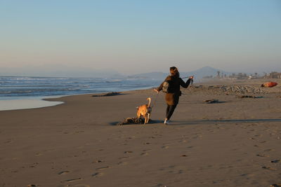 Woman with dog on beach