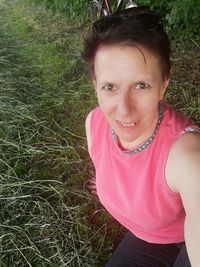 Portrait of a smiling young woman on field