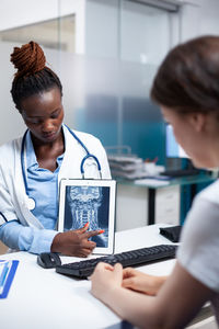 Side view of doctor working at office