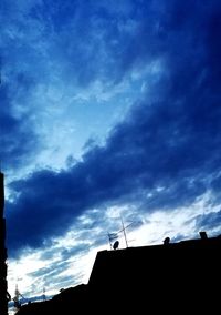 Low angle view of silhouette building against sky