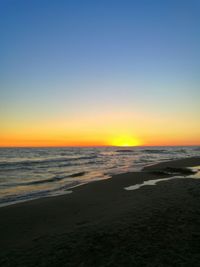 Scenic view of calm sea at sunset