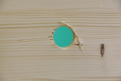 High angle view of coffee cup on wooden table