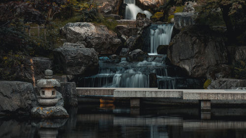 Fountain in front of waterfall