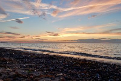 Scenic view of beach against sky during sunset