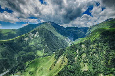 Scenic view of green mountains against sky