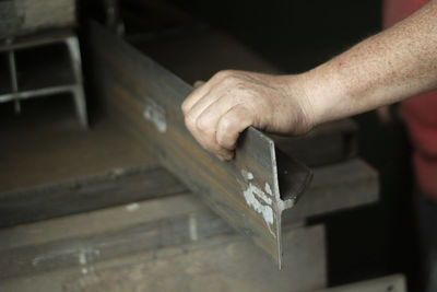 Cropped hands of man working in workshop