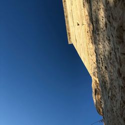 Low angle view of built structure against blue sky