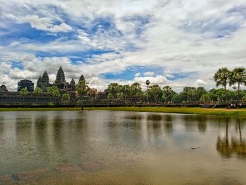 Scenic view of calm lake against cloudy sky