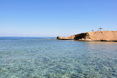 Scenic view of sea against clear blue sky