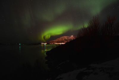 Scenic view of lake against sky at night