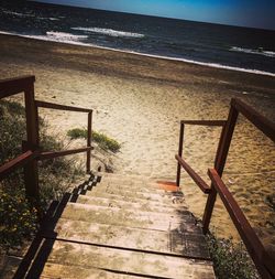 Steps on beach against sky