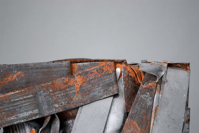 Close-up of rusty metal against gray background