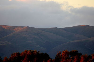 Scenic view of mountain against cloudy sky