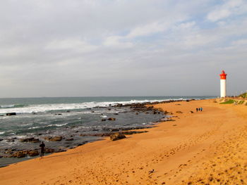 Distance shot of lighthouse on calm beach