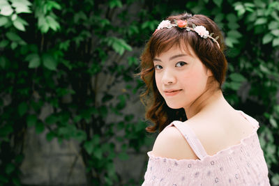 Portrait of young woman standing outdoors